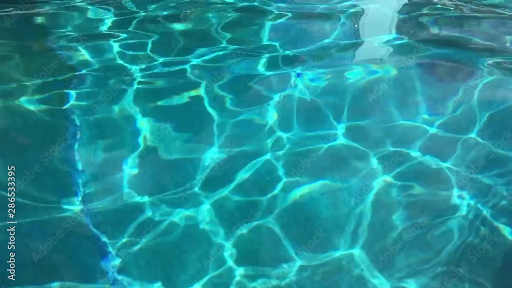 Water abstract background, Swimming pool rippled. Hotel swimming pool with sunny reflections Water abstract background, Swimming pool rippled. Hotel swimming pool with sunny reflections