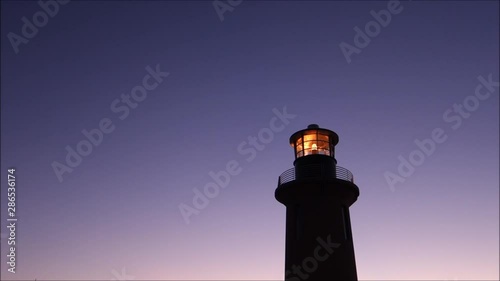 lighthouse at dusk with rotating light