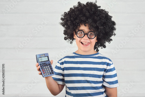 funny child with calculator wearing nerd glasses