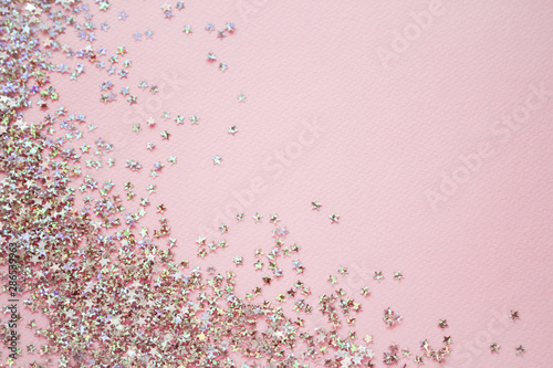 Golden stars glitter on pink background. Flat lay