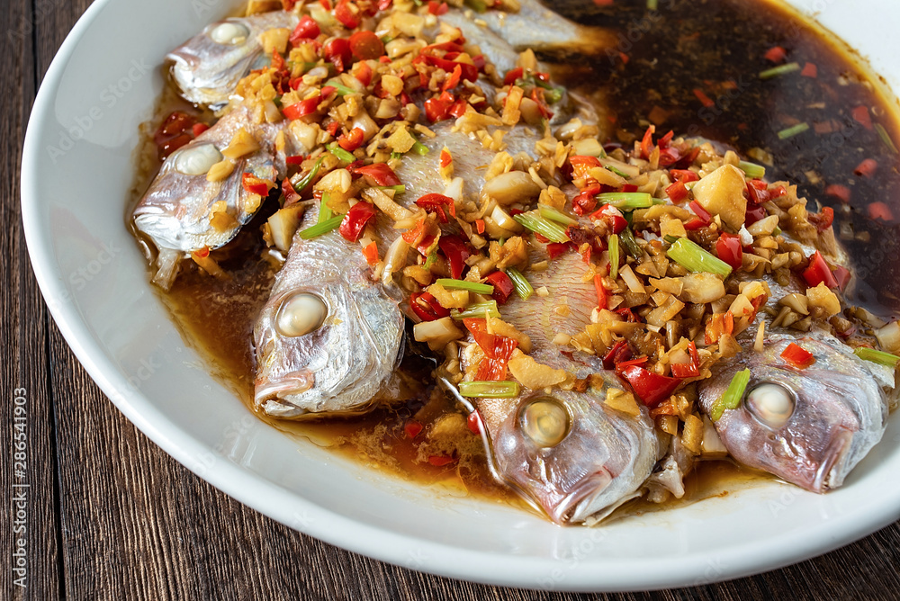 Chinese cuisine chili steamed red squid on wooden board background Chinese cuisine chili steamed red squid on wooden board background