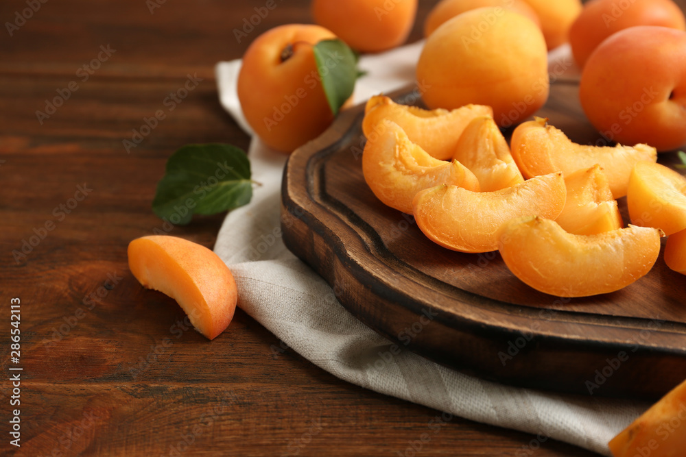 Composition with delicious ripe sweet apricots on wooden table, space for text