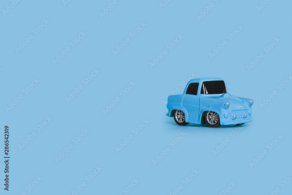 blue retro toy car on an isolated blue background blue retro toy car on an isolated blue background