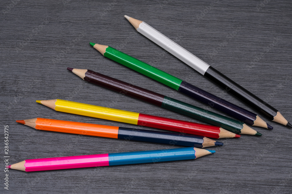 Colored pencils isolated on dark wooden background Colored pencils isolated on dark wooden background