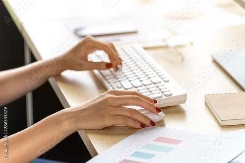 Close-up of women sitting working at the desk