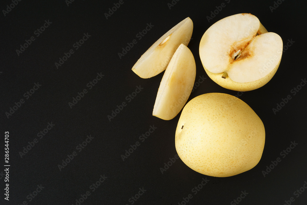 Top view Sand pear full and slice fruit isolated on black background