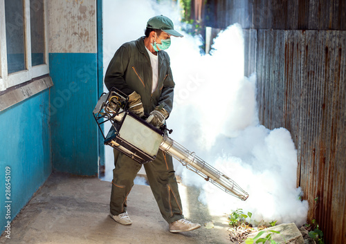 The man's fogging to eliminate mosquito for preventing spread dengue fever and prevent other diseases that have mosquitoes causing the disease