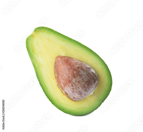 Half of ripe avocado with pit on white background