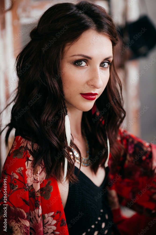 Portrait of beautiful young brunette woman with makeup in bright clothing