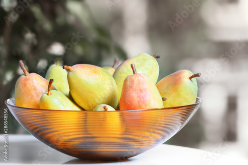 Fresh ripe pears on light table indoors