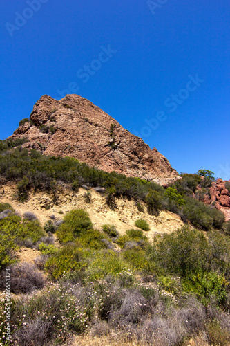Tonal Mountain in Malibu with Shrubs growing  Set against a pure blue sky