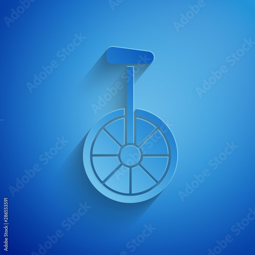 Paper cut Unicycle or one wheel bicycle icon isolated on blue background. Monowheel bicycle. Paper art style. Vector Illustration