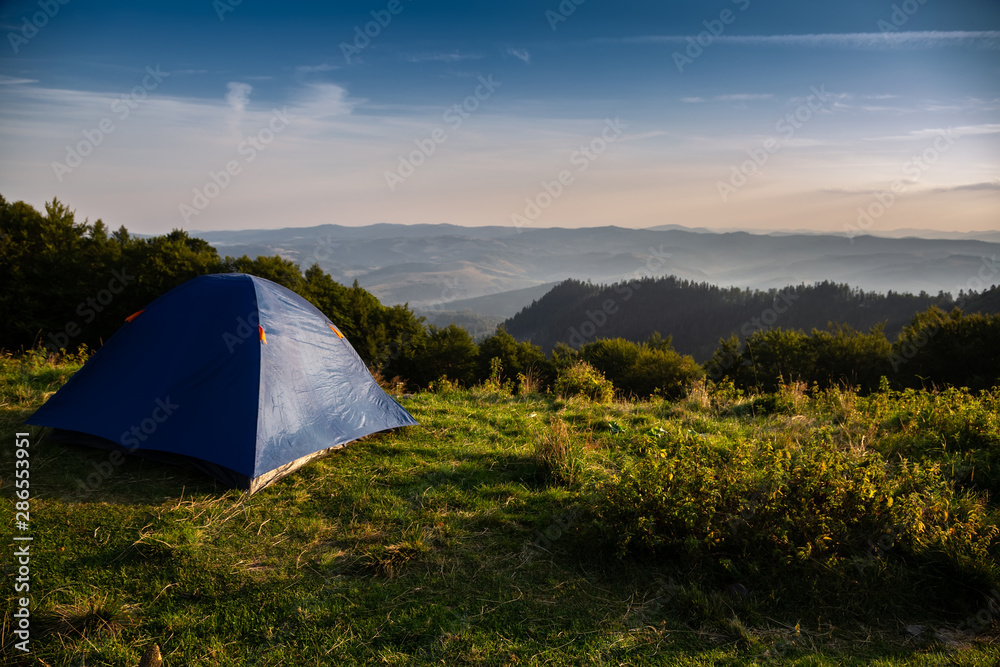 Beautiful mountain landscape with a tourist tent. Carpathian mountains of Ukraine. Holidays in the mountains.