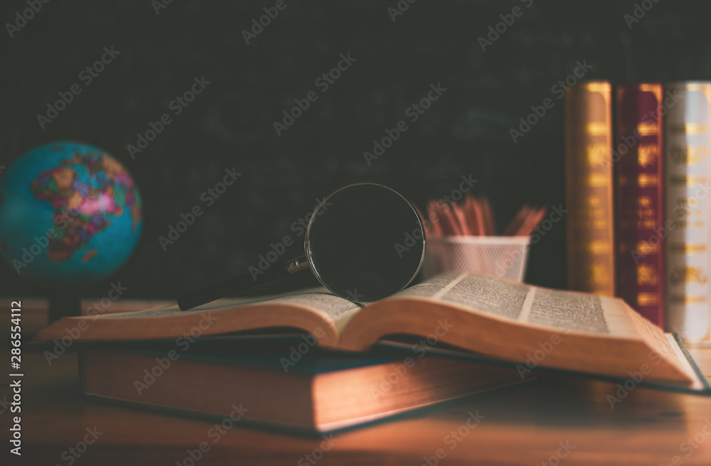 Textbooks, globe and pencils on a wooden background. Educational background, Back to School background concept. - obrazy, fototapety, plakaty 