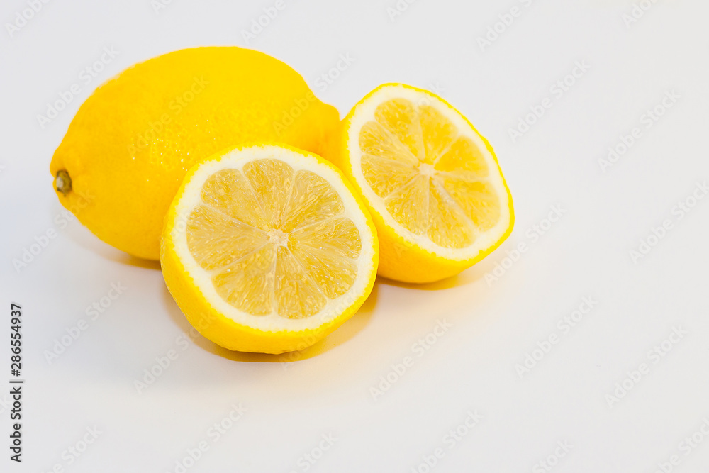 lemons and lemon slices on white background