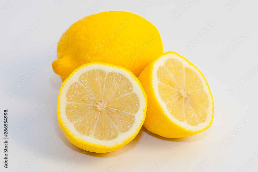 lemons and lemon slices on white background