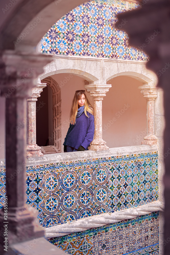 Fototapeta Young woman contemplating the courtyard of Quinta da Regaleira in Sintra, Portugal