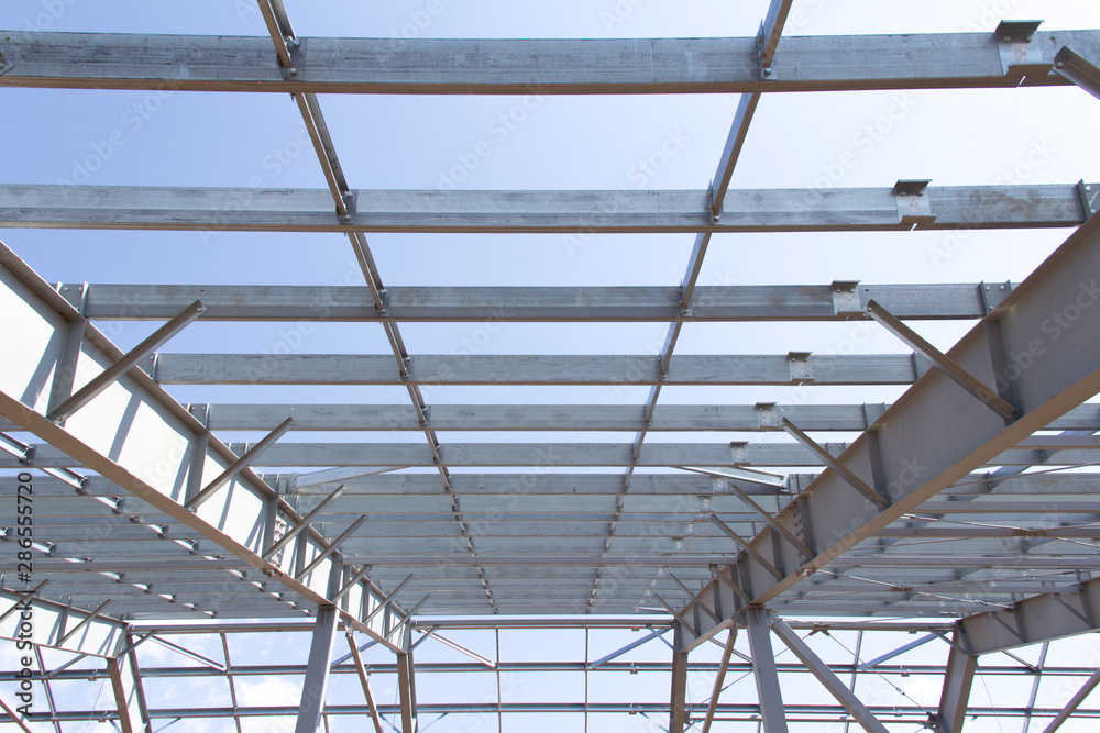 Steel structure of building construction on blue sky background Steel structure of building construction on blue sky background