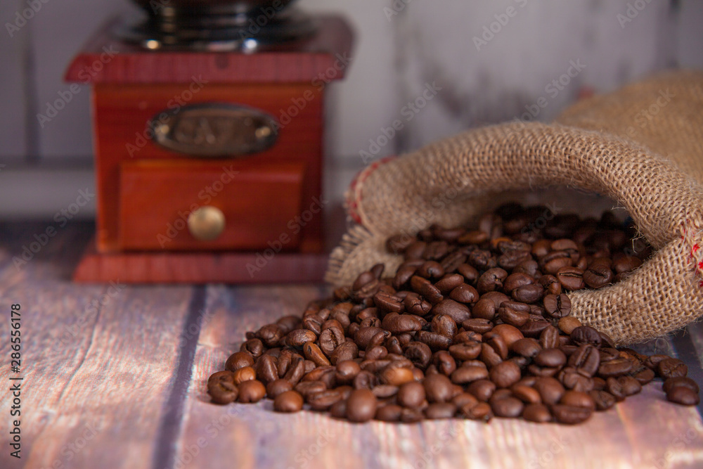 coffee beans coming out of a sack and grinder coffee