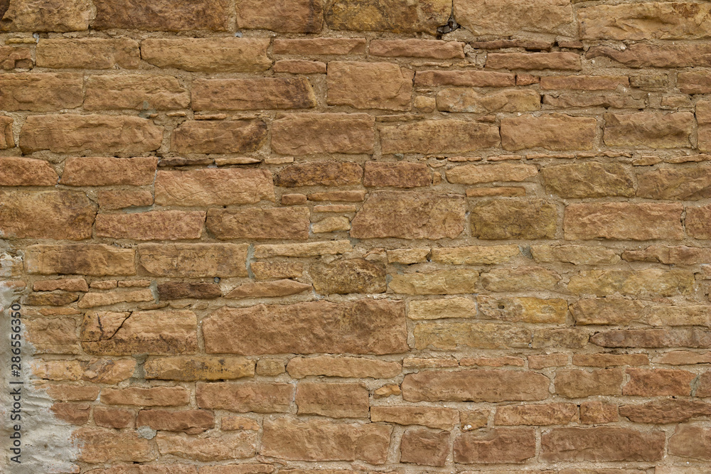 Antique light brown limestone wall texture with thick mortar and grunge look Antique light brown limestone wall texture with thick mortar and grunge look
