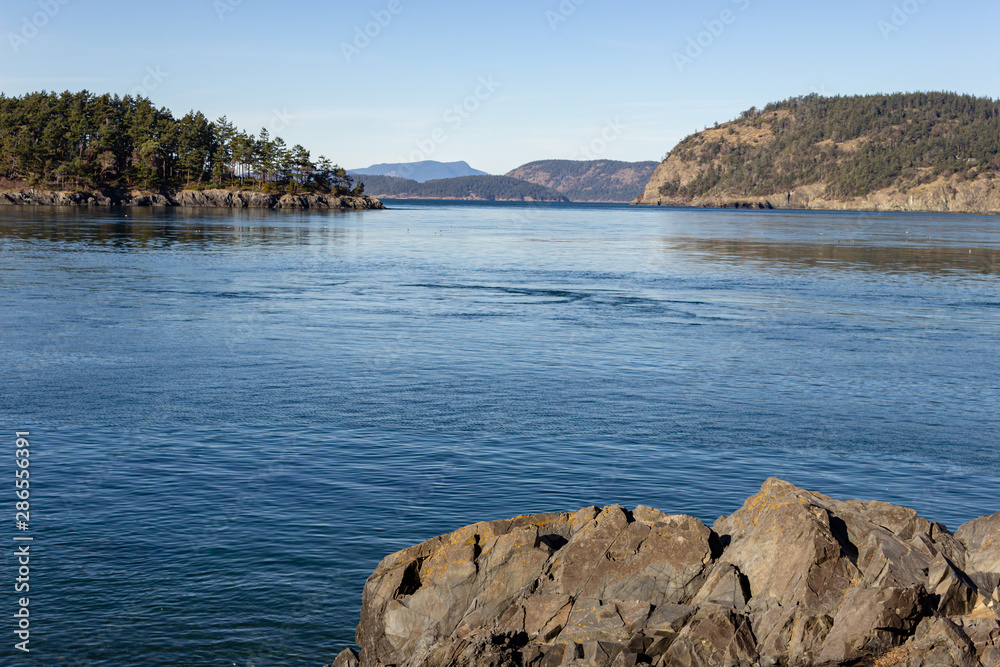 Fototapeta premium Stunning rock formation. From the West Point excellent views of the water passage at Deception Pass, an excellent vantage point for bird watching and scenic hikes along the shoreline.