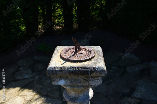 metal sundial on concrete plinth photo