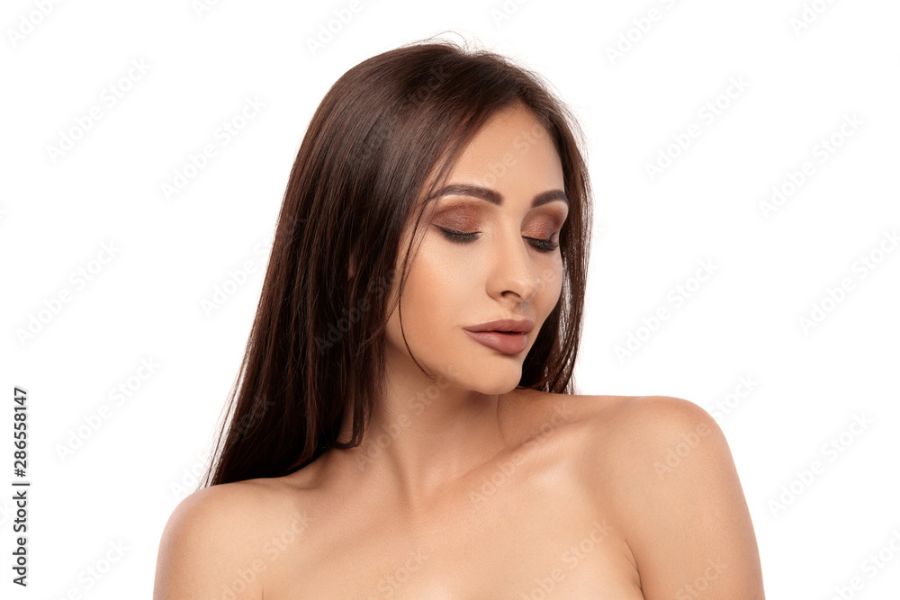 Close up portrait of a brunette nude model girl with professional evening make-up and plump lips, posing isolated on white background. Close up portrait of a brunette nude model girl with professional evening make-up and plump lips, posing isolated on white background.