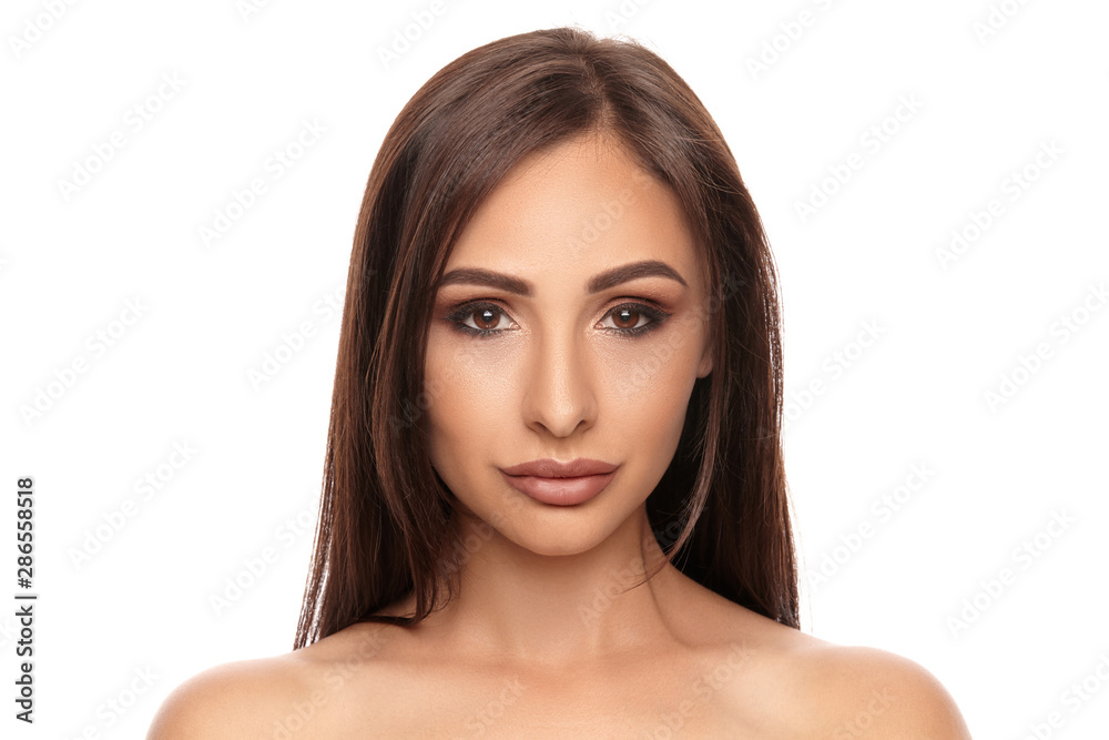 Close up portrait of a brunette nude model girl with professional evening make-up and plump lips, posing isolated on white background.
