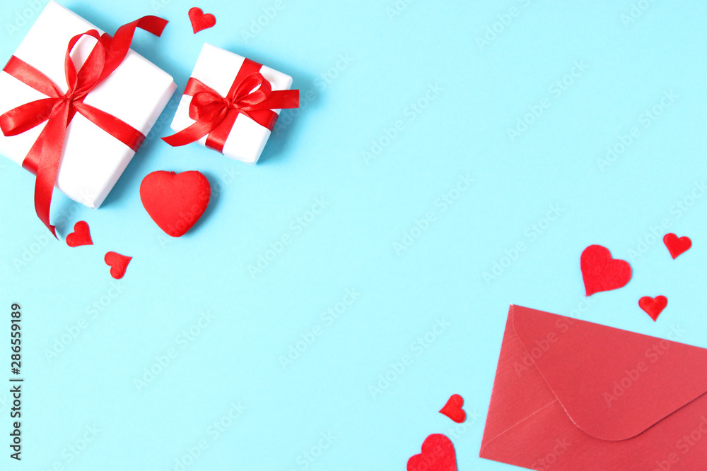 Gifts and hearts on a colored background top view. Love. Valentine's day background with place for text insertion. Gifts and hearts on a colored background top view. Love. Valentine's day background with place for text insertion.