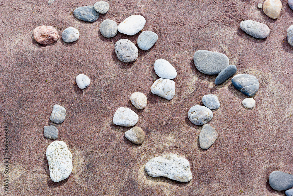 Beach red and yellow sand and sea stones Beach red and yellow sand and sea stones
