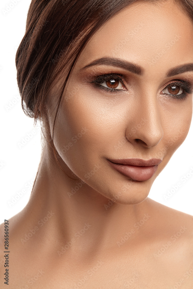 Close up portrait of a brunette nude model girl with professional evening make-up and plump lips, posing isolated on white background. Close up portrait of a brunette nude model girl with professional evening make-up and plump lips, posing isolated on white background.
