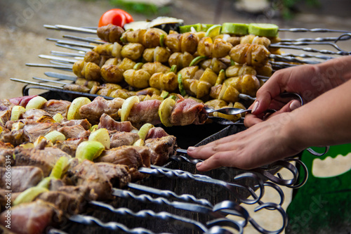 skewers on skewers languish on the grill in smoke