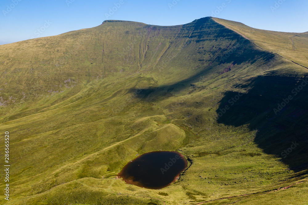 Aerial drone view of the twin peaks of mountains Corn Du and Pen-y-Fan in the Brecon Beacons of Wales, UK - obrazy, fototapety, plakaty 