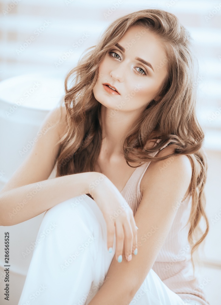 Portrait of beautiful young blonde woman with makeup in fashion clothes Portrait of beautiful young blonde woman with makeup in fashion clothes