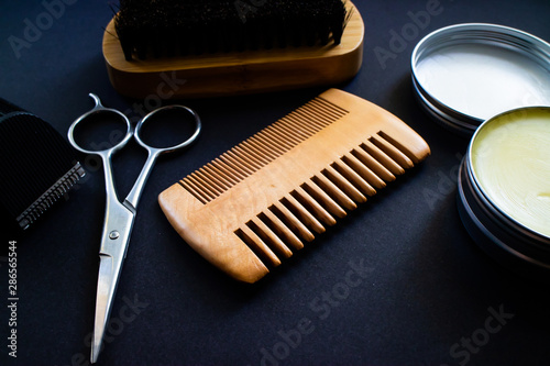Materials for a perfect beard. Scissor, shaver, comb, wax and brush, all made with natural materials