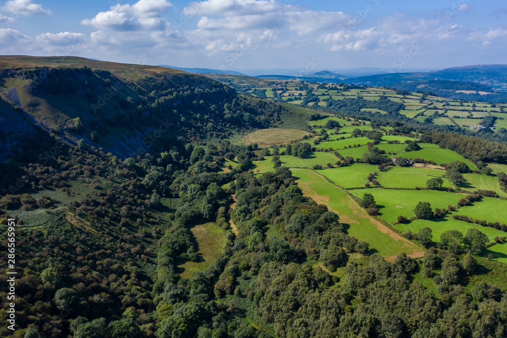 Aerial drone view of an old quarry and limestone cliffs at Llangattock in South Wales, UK