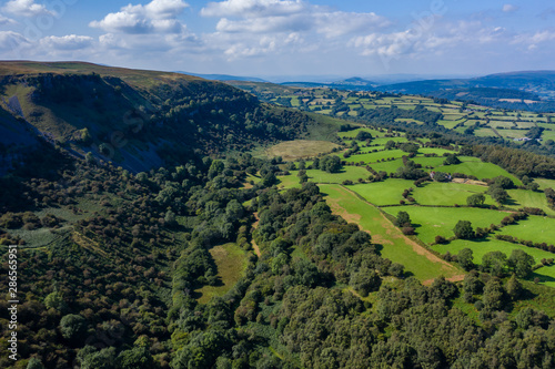 Aerial drone view of an old quarry and limestone cliffs at Llangattock in South Wales, UK