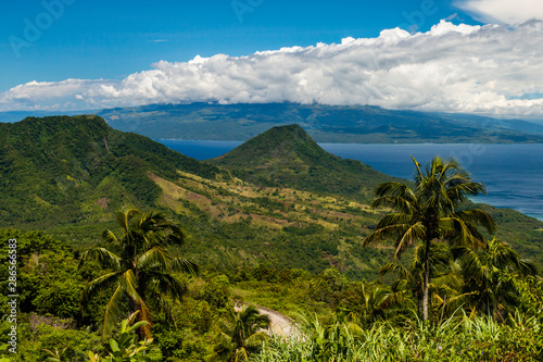 View of green volcanic peaks and clouds from the Philippines island of Camiguin