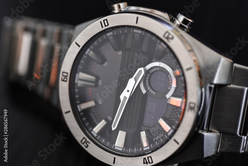 Luxury quartz watch with analog hands and a digital display and a solar battery, tachometer photo