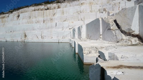 Mineral water turguise lake against the blue cloudy sky in sunny day at marble mine, pamukkale photo