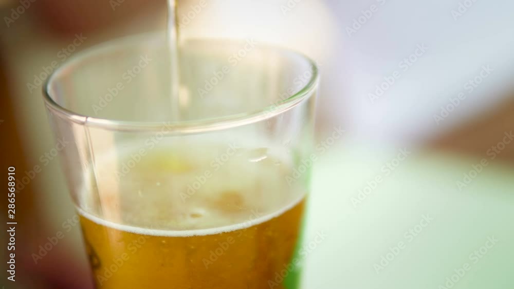 Selective focus of fresh cold beer pouring in glass Selective focus of fresh cold beer pouring in glass