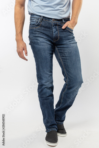 man in jeans, denim pants closeup on white background, blue jeans