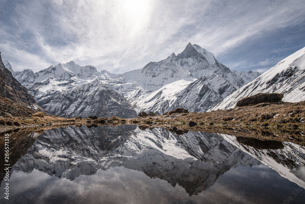 reflection of machapuchare peak in himalayas annapurna base camp trekking route 