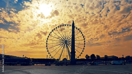 City traffic on Place de la Concorde near Obelisk of Luxor at spring sunrise. Luxor Obelisk is over 3000 years old. Hyperlapse footage photo