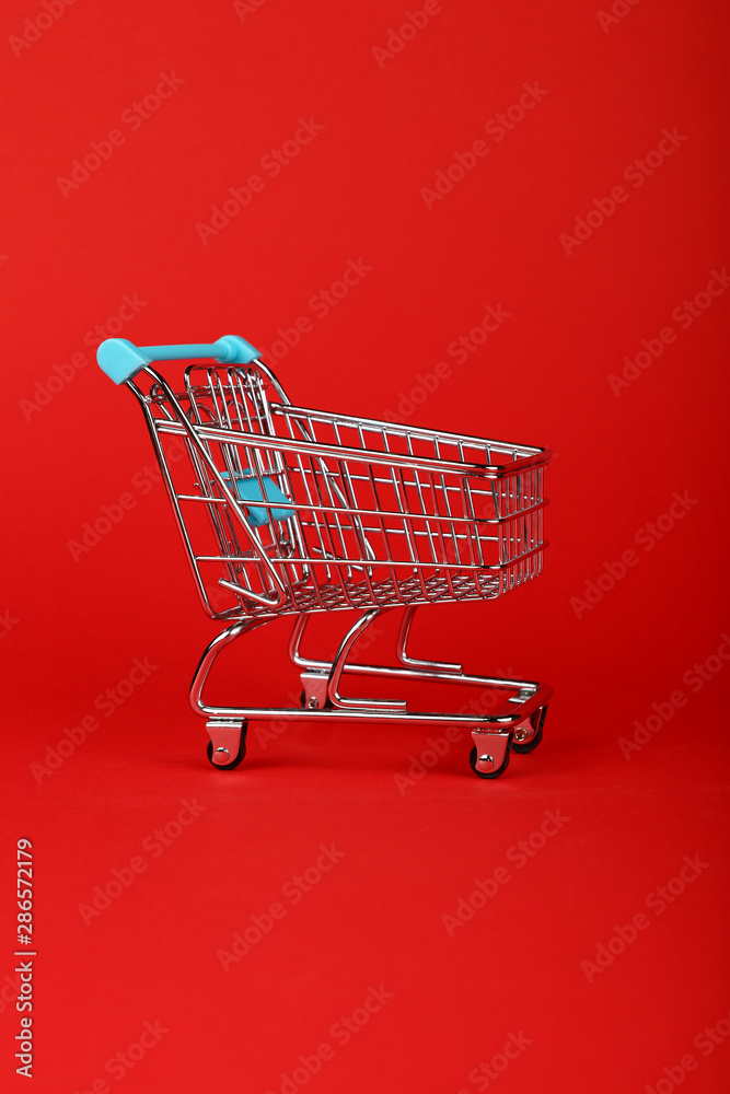 Close up retail shopping cart on red background Close up retail shopping cart on red background
