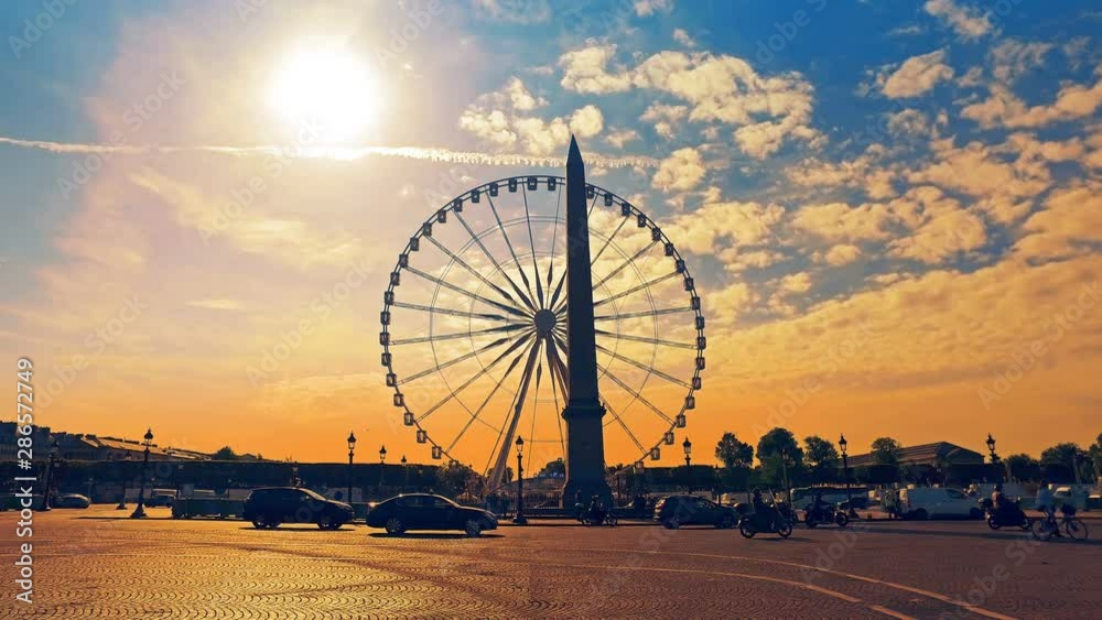 Traffic at sunrise in Place De La Concorde. The Fontaines de la Concorde and obelisk are visible. Hyperlapse cinematic shot Traffic at sunrise in Place De La Concorde. The Fontaines de la Concorde and obelisk are visible. Hyperlapse cinematic shot