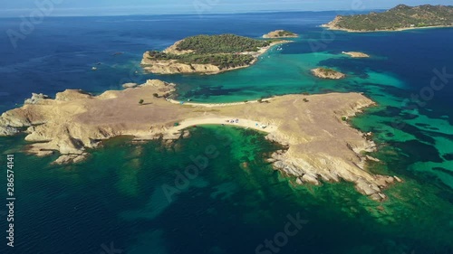 Aerial drone view video of paradise small secluded island complex of Drenia and Pena with turquoise and sapphire sea near famous Amouliani island in North Greece, Halkidiki photo