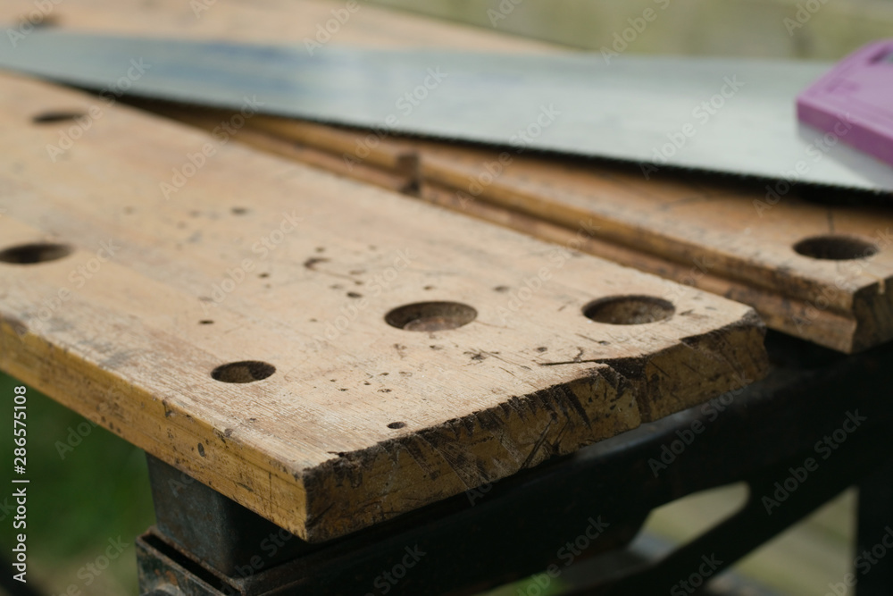 Wooden workbench with saw for DIY and carpentry work Wooden workbench with saw for DIY and carpentry work