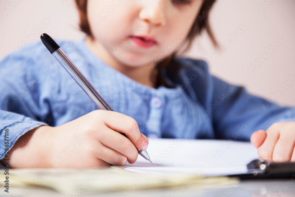 Humorous photo of cute little business child girl signs a contract. Business, agreement, success, profit. Humorous photo of cute little business child girl signs a contract. Business, agreement, success, profit.