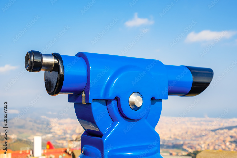 The blue stationary spyglass for sightseeing with magnification. Telescope